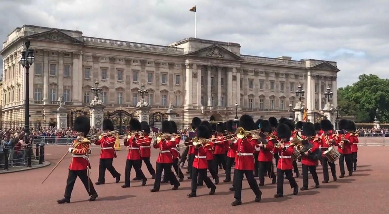 Military band and Foot Guards marching in front of Buckingham Palace